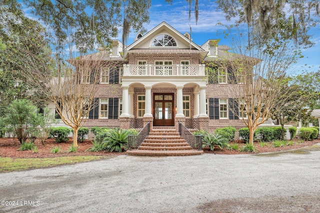 view of front of house featuring french doors and a balcony