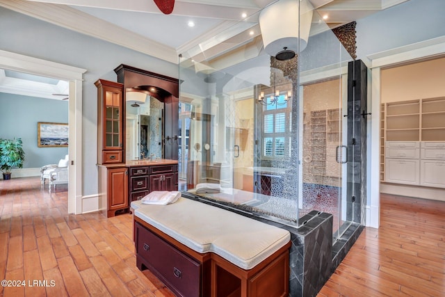 bathroom featuring walk in shower, vanity, crown molding, and hardwood / wood-style floors