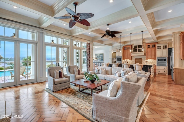 living room with light parquet floors, a high ceiling, coffered ceiling, french doors, and beamed ceiling