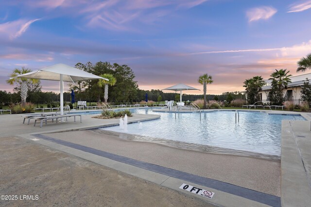 782 Azalea Dr, Hardeeville, SC 29927 - pool at dusk featuring a community pool and a patio area