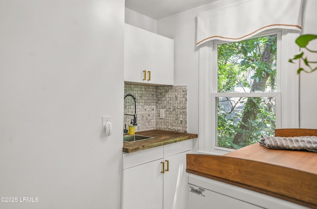 70 Dolphin Point Dr, Beaufort, SC 29907 - kitchen with decorative backsplash, white cabinets, and white dishwasher