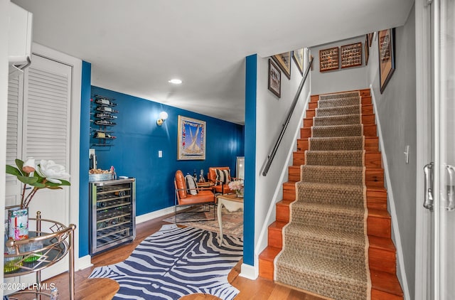 70 Dolphin Point Dr, Beaufort, SC 29907 - staircase featuring wine cooler, wood finished floors, recessed lighting, and bar