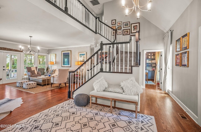 70 Dolphin Point Dr, Beaufort, SC 29907 - staircase featuring a chandelier, wood finished floors, and a high ceiling