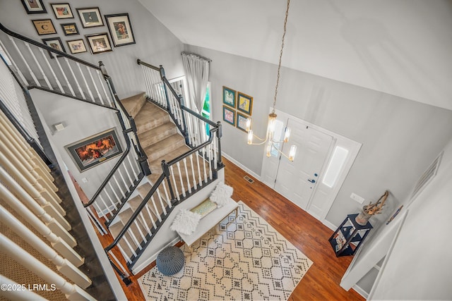 70 Dolphin Point Dr, Beaufort, SC 29907 - entryway with stairway, a chandelier, wood finished floors, and vaulted ceiling