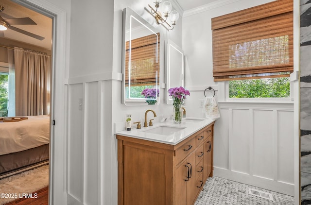 70 Dolphin Point Dr, Beaufort, SC 29907 - bathroom with double vanity, a decorative wall, ceiling fan, a wainscoted wall, and ensuite bath