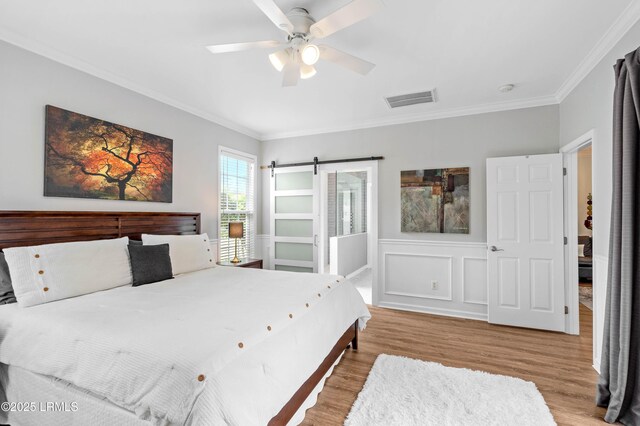 170 Pinecrest Cir, Bluffton, SC 29910 - bedroom with ornamental molding, wood finished floors, a wainscoted wall, and a ceiling fan