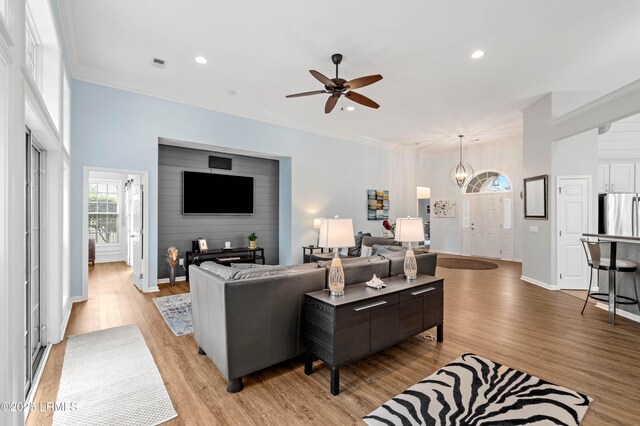 170 Pinecrest Cir, Bluffton, SC 29910 - living room with light wood-type flooring, ornamental molding, a chandelier, ceiling fan, and recessed lighting