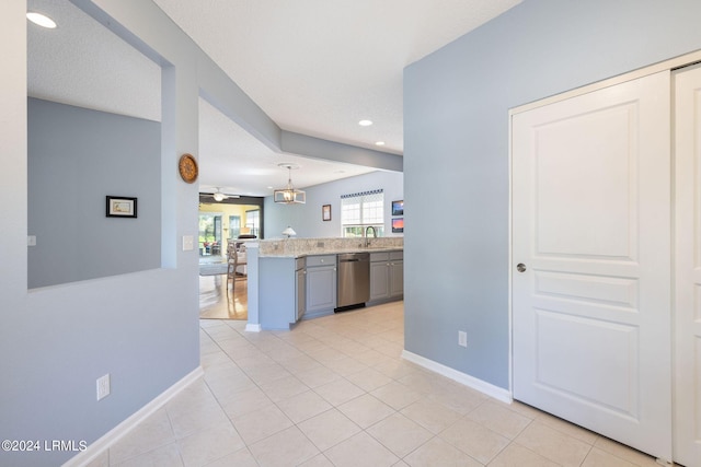 kitchen featuring sink, gray cabinetry, decorative light fixtures, kitchen peninsula, and dishwasher