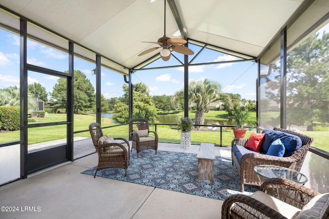 sunroom / solarium featuring lofted ceiling with beams, a ceiling fan, and a water view