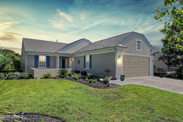 ranch-style home with concrete driveway, roof with shingles, a yard, and stucco siding