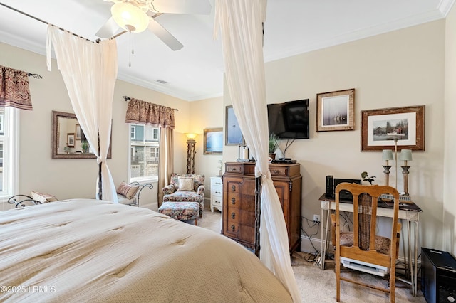 bedroom with carpet floors, visible vents, baseboards, a ceiling fan, and ornamental molding