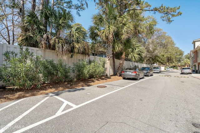 view of car parking featuring fence