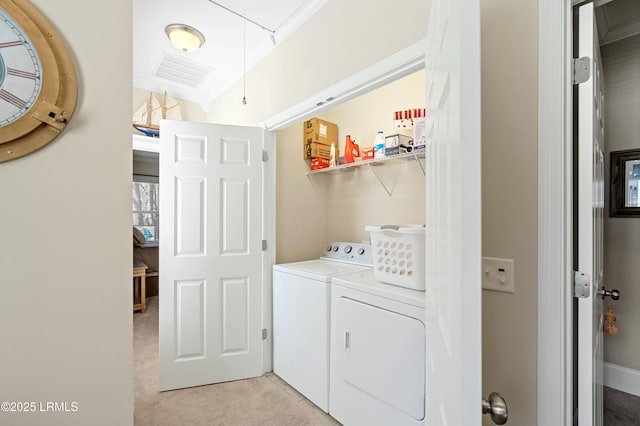 laundry room featuring washer and clothes dryer, visible vents, attic access, light carpet, and laundry area