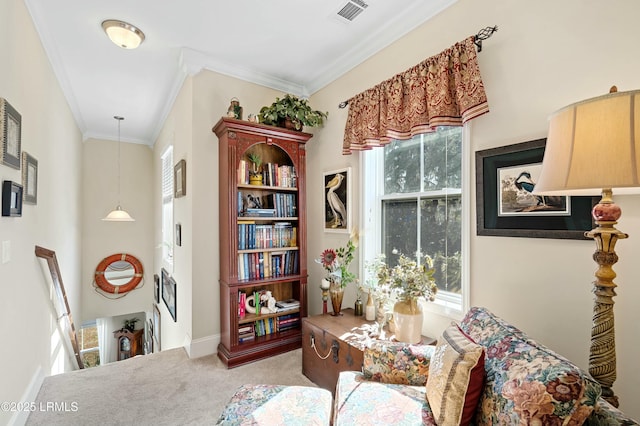 living area with baseboards, visible vents, crown molding, and carpet flooring