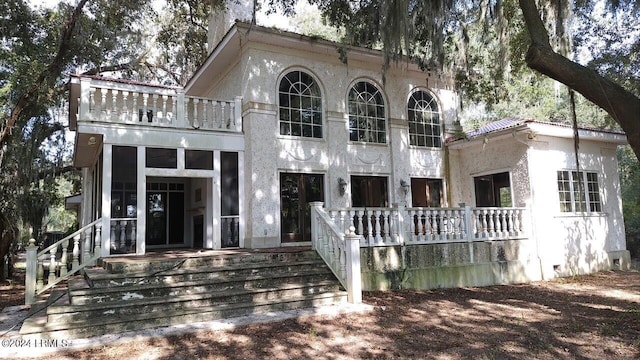 rear view of property with a sunroom