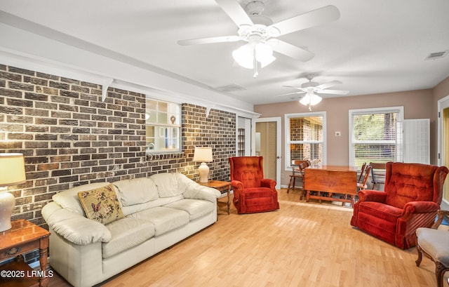 28 Walnut Hill St, Beaufort, SC 29907 - living room with a ceiling fan, brick wall, and wood finished floors