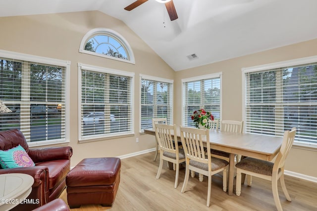 dining space featuring vaulted ceiling, ceiling fan, and light hardwood / wood-style flooring