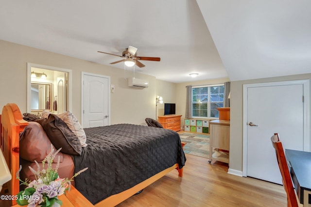 bedroom featuring an AC wall unit and light wood-type flooring