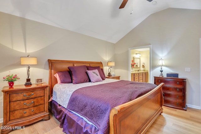 bedroom with ceiling fan, ensuite bath, vaulted ceiling, and light hardwood / wood-style flooring