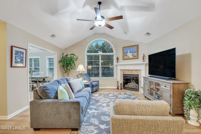 living room with vaulted ceiling, ceiling fan, and light hardwood / wood-style floors