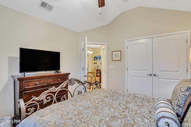 bedroom with lofted ceiling, ceiling fan, and a closet