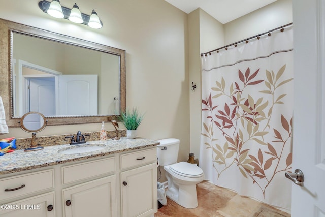 bathroom featuring vanity, a shower with shower curtain, tile patterned floors, and toilet