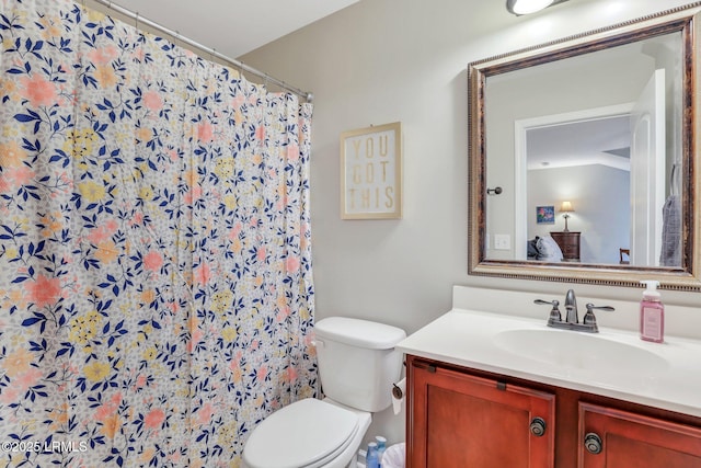 bathroom with vanity, lofted ceiling, a shower with shower curtain, and toilet