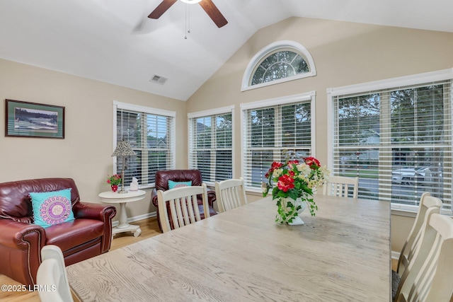 dining area with hardwood / wood-style flooring, lofted ceiling, and ceiling fan