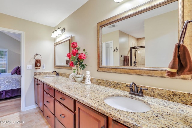 bathroom with vanity, tile patterned floors, and walk in shower