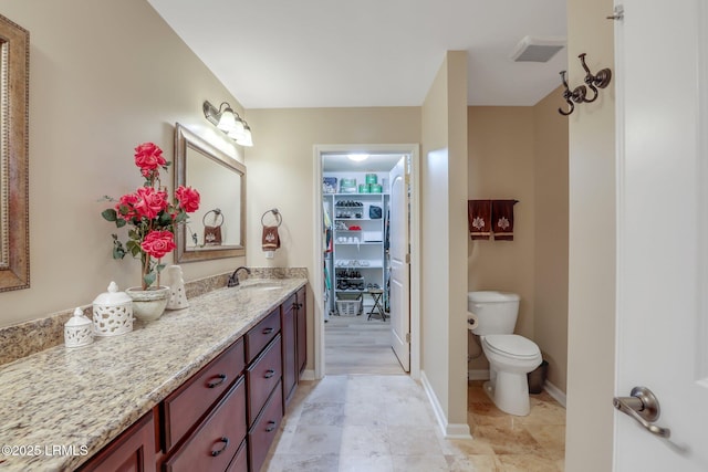 bathroom with vanity and toilet