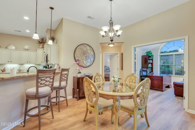 dining room featuring a chandelier and light hardwood / wood-style floors