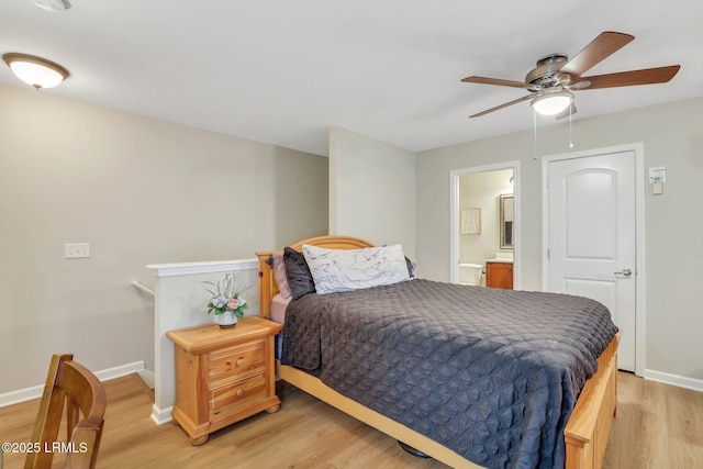 bedroom featuring connected bathroom, ceiling fan, and light wood-type flooring