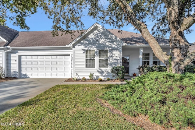 ranch-style home with a garage and a front lawn