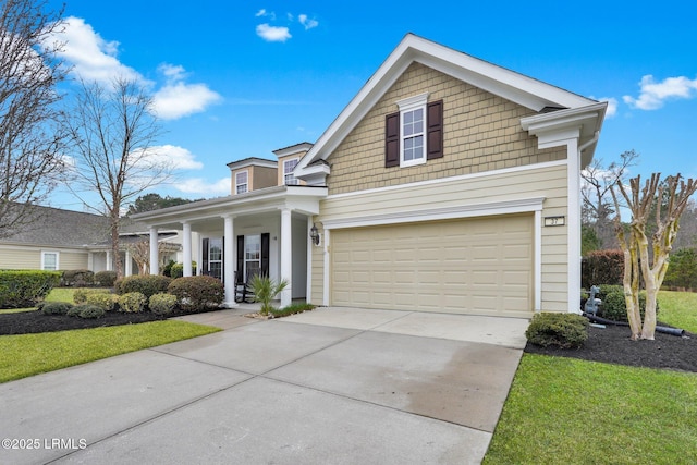 traditional-style house with covered porch, driveway, and an attached garage