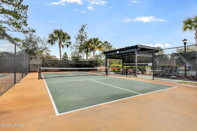 view of sport court featuring fence