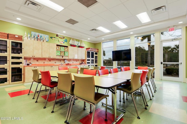 dining space with a drop ceiling, visible vents, and recessed lighting