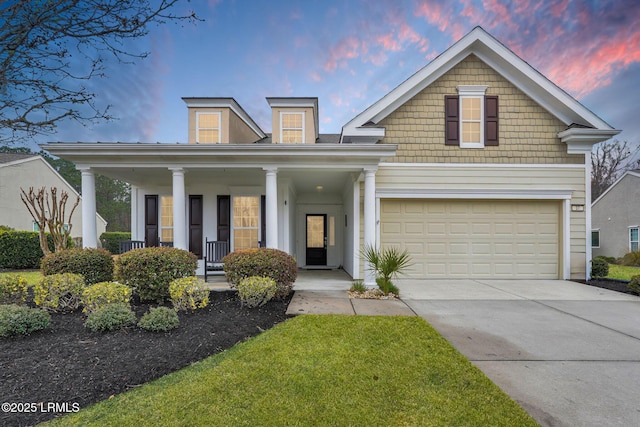 view of front facade featuring a garage, a porch, and concrete driveway