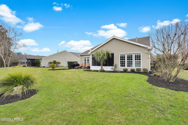 back of house with a lawn and stucco siding