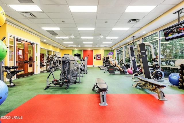 workout area with visible vents and a drop ceiling