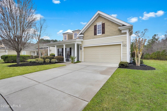 view of front of house featuring a garage, a front yard, concrete driveway, and a porch