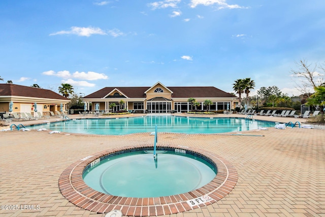 pool with a patio and a community hot tub