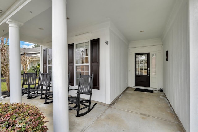 view of exterior entry featuring a porch