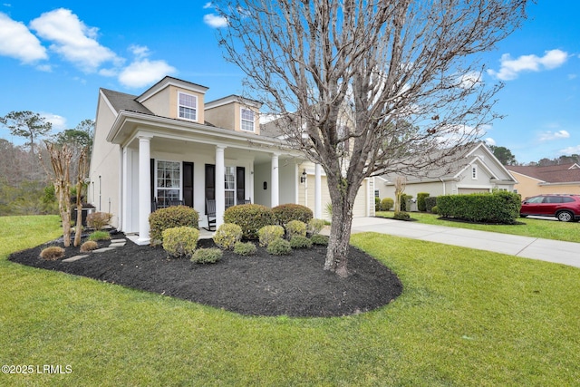 view of front of home with driveway, stucco siding, an attached garage, and a front yard