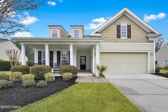 view of front facade featuring driveway, a porch, and an attached garage