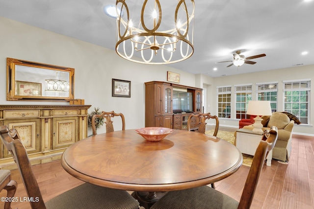 dining area with ceiling fan, visible vents, and light wood-style flooring