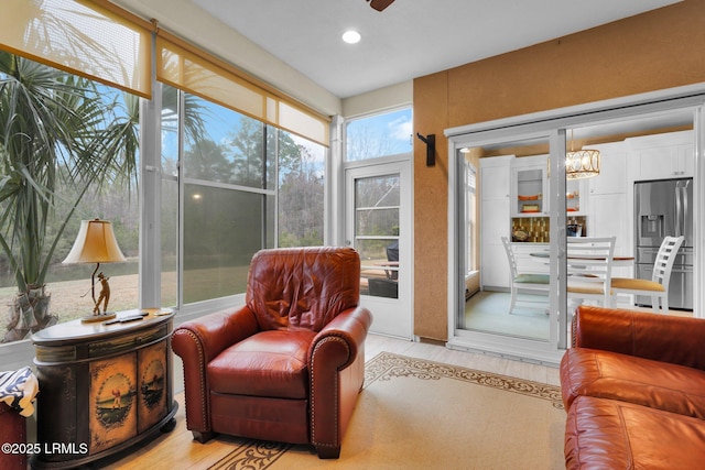 sunroom featuring a chandelier