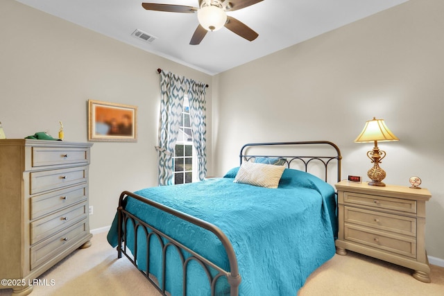 bedroom featuring a ceiling fan, visible vents, light carpet, and baseboards