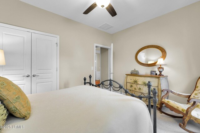 carpeted bedroom featuring a closet, visible vents, and ceiling fan