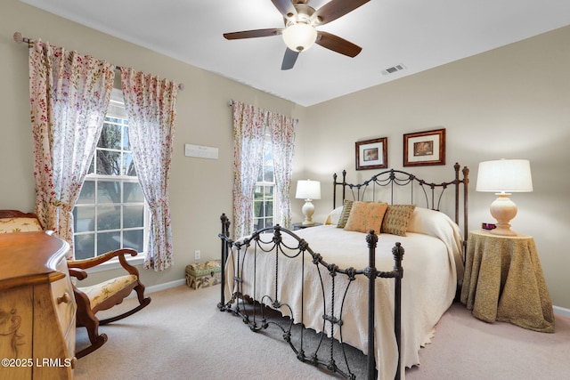 carpeted bedroom with baseboards, visible vents, and ceiling fan