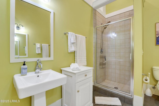 10 Abbey Row Unit 1A, Beaufort, SC 29906 - bathroom featuring tile patterned flooring, toilet, a stall shower, and a sink
